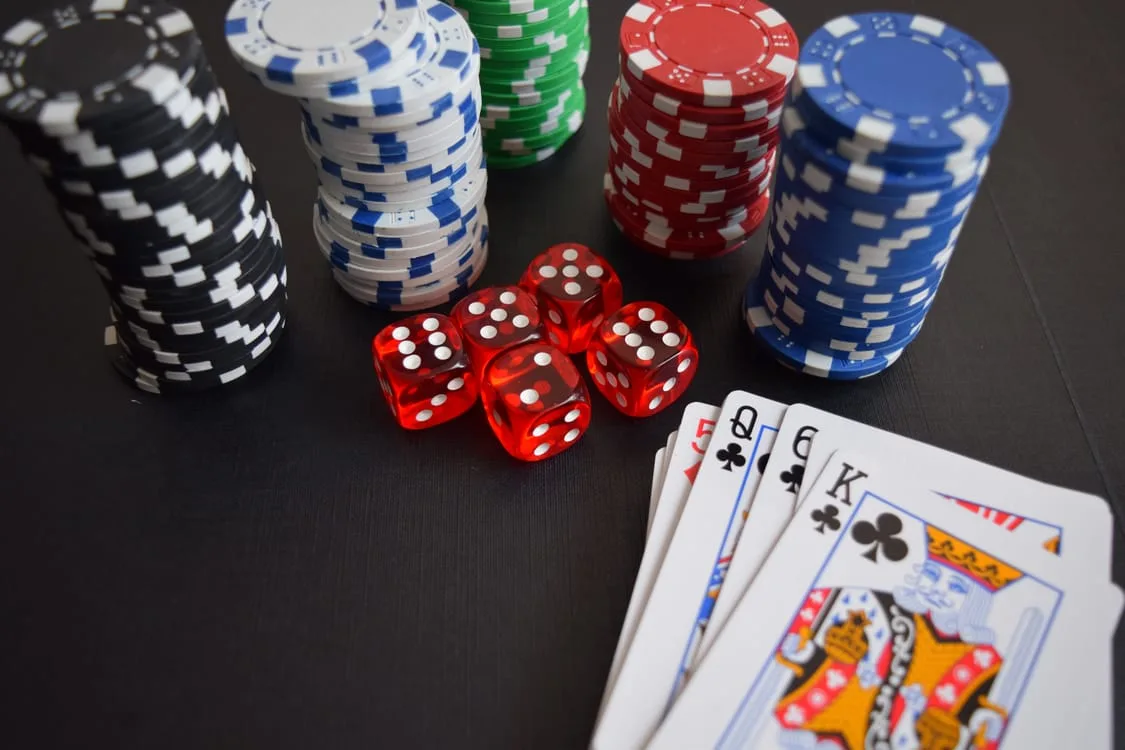 Yukon Solitaire tableau with cards spread across seven columns on a wooden table